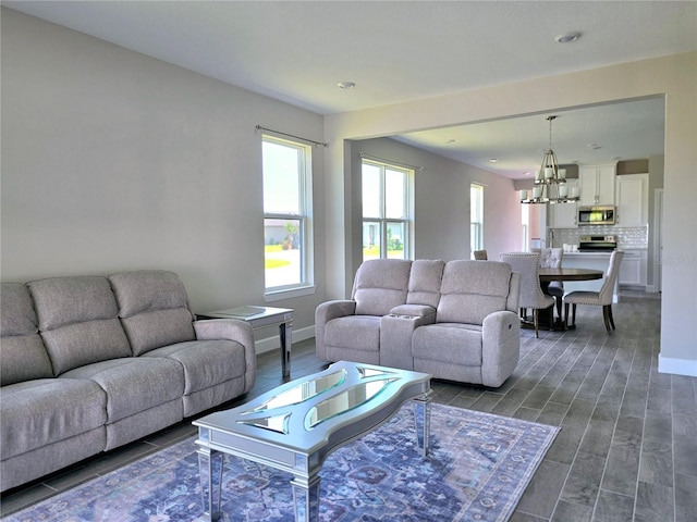 living room featuring dark wood-type flooring and an inviting chandelier