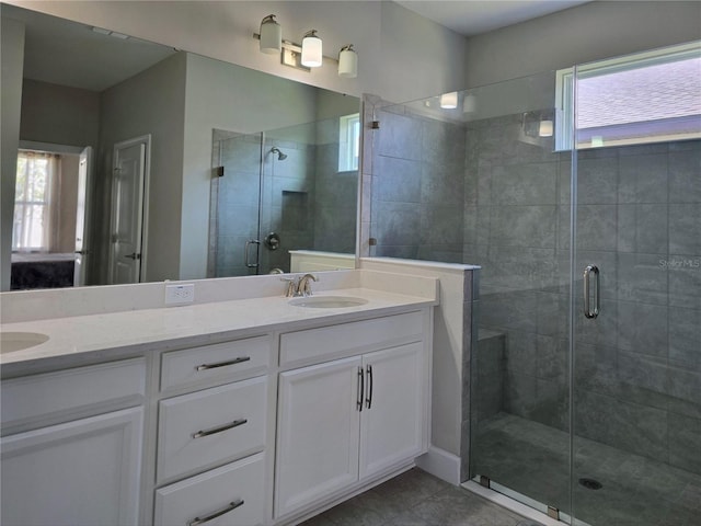 bathroom with vanity, tile patterned floors, and a shower with door