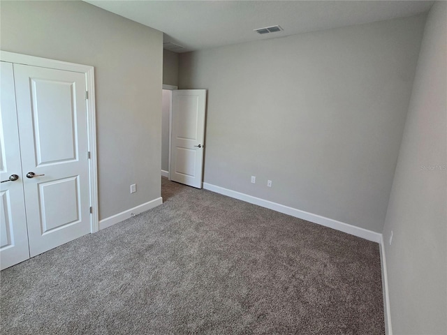 unfurnished bedroom with a closet and carpet floors