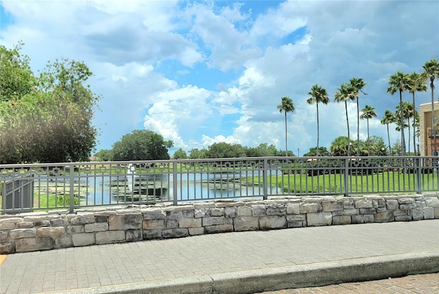 surrounding community featuring a yard and a water view