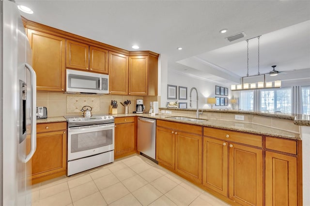 kitchen with pendant lighting, stainless steel appliances, sink, and kitchen peninsula