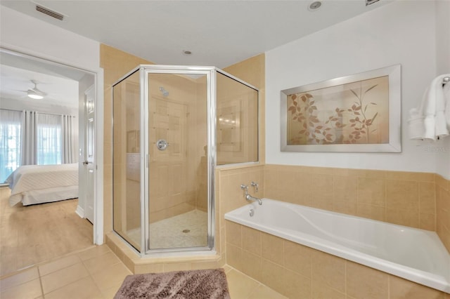 bathroom with plus walk in shower, tile patterned floors, and ceiling fan