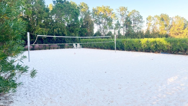 surrounding community featuring a water view and volleyball court