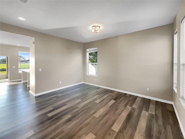 spare room featuring dark hardwood / wood-style flooring