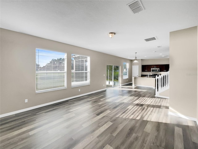 unfurnished living room featuring light hardwood / wood-style floors and a healthy amount of sunlight