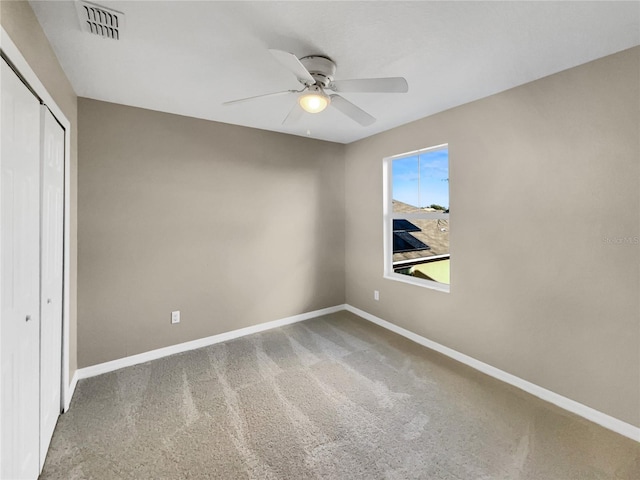 unfurnished bedroom featuring a closet, ceiling fan, and carpet floors