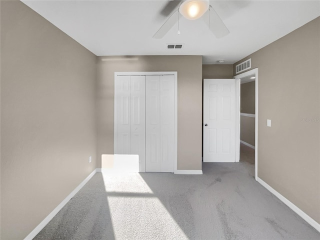 unfurnished bedroom with carpet flooring, a closet, and ceiling fan