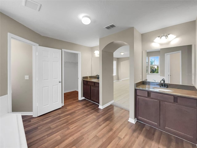 kitchen with dark brown cabinets, sink, and dark wood-type flooring