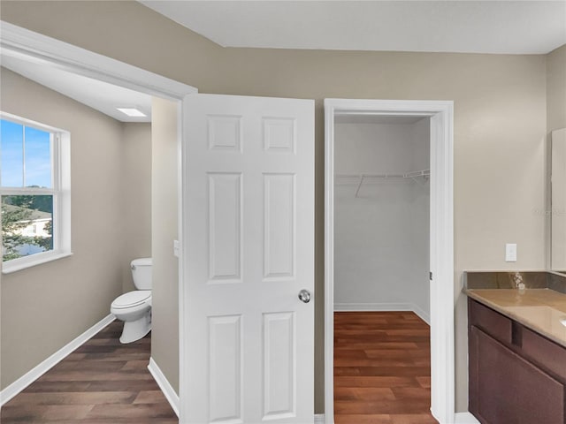 bathroom with vanity, hardwood / wood-style flooring, and toilet