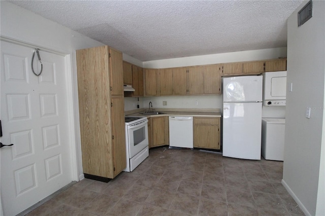 8209 Sun Spring Cir Unit 22, Orlando, FL 32825 - kitchen with white appliances, light tile patterned flooring, sink, a textured ceiling, and stacked washer and clothes dryer
