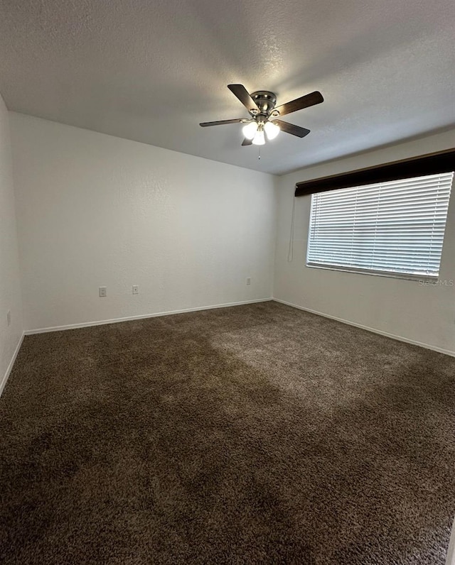 carpeted empty room with a textured ceiling and ceiling fan