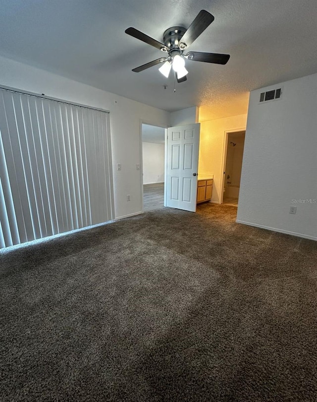 unfurnished room featuring a textured ceiling, carpet floors, and ceiling fan