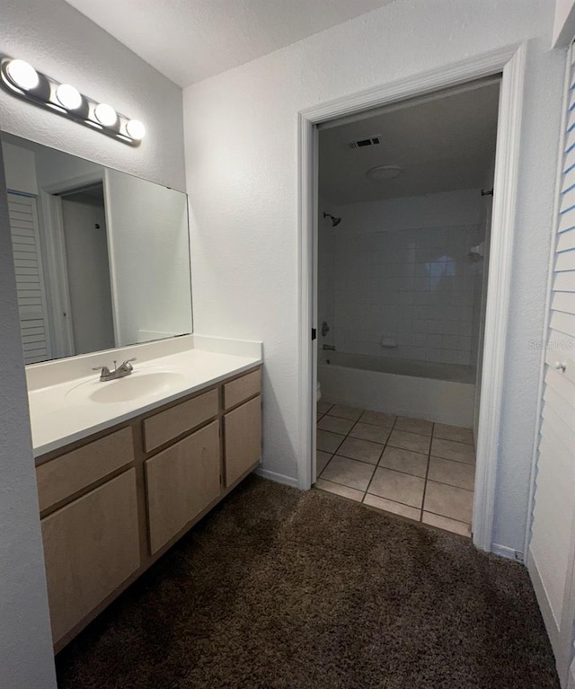 bathroom with vanity, tile patterned floors, and tiled shower / bath