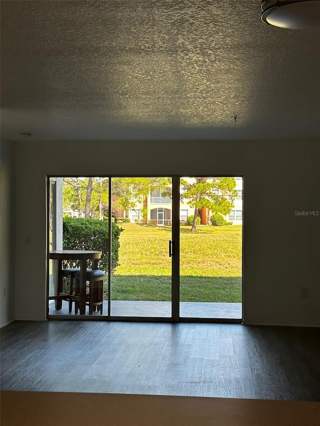 entryway featuring hardwood / wood-style floors and a textured ceiling