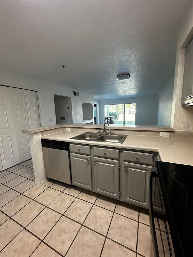 kitchen with gray cabinetry, stove, sink, dishwasher, and kitchen peninsula