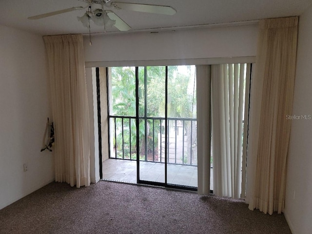 carpeted empty room featuring ceiling fan