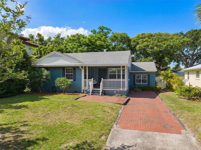 ranch-style home with a front yard and covered porch