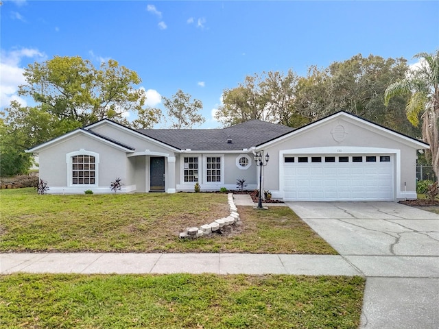 single story home with driveway, a front lawn, an attached garage, and stucco siding