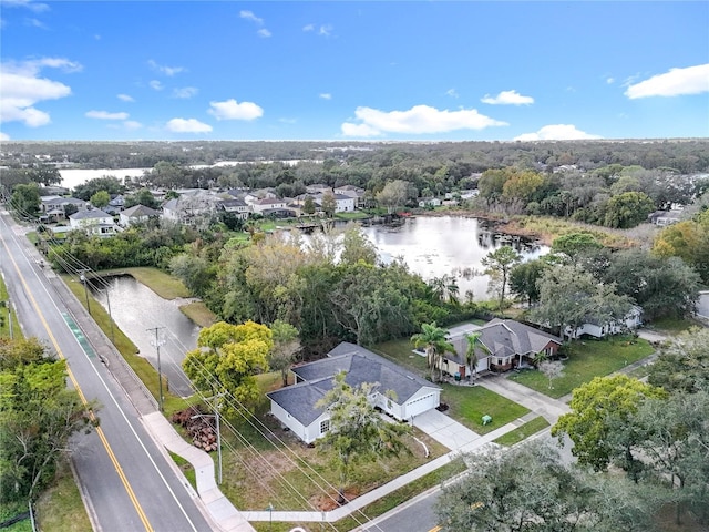 drone / aerial view featuring a water view and a residential view