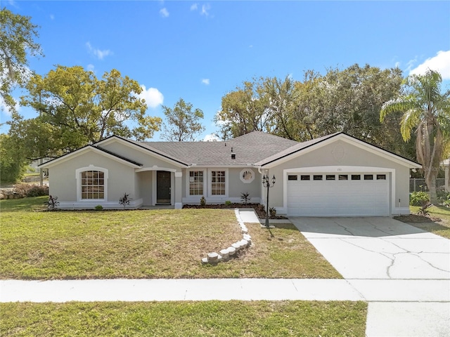 ranch-style house with an attached garage, stucco siding, concrete driveway, and a front yard