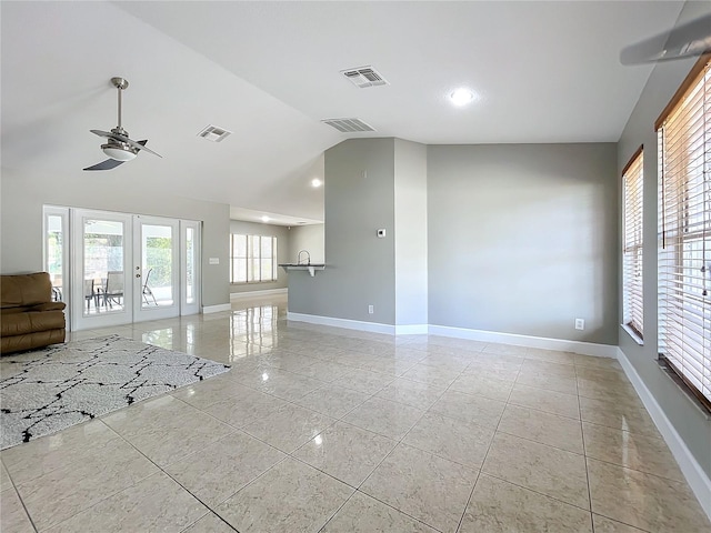 unfurnished living room featuring french doors, visible vents, vaulted ceiling, and baseboards