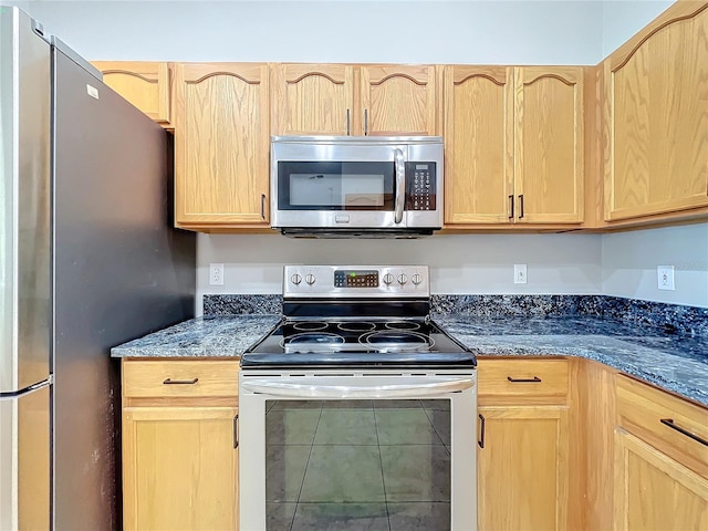 kitchen featuring stainless steel appliances and light brown cabinetry