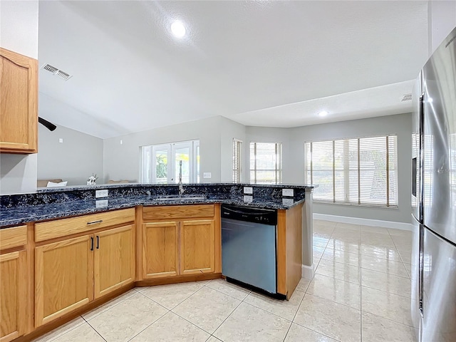 790 Silhouette Ct, Longwood, FL 32750 - kitchen featuring stainless steel appliances, a sink, dark stone counters, light tile patterned floors, and lofted ceiling