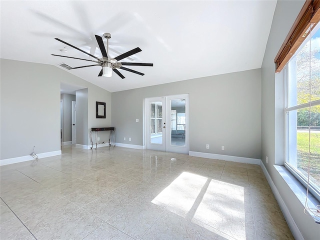 empty room with french doors, lofted ceiling, visible vents, ceiling fan, and baseboards