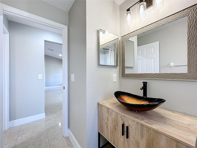 bathroom featuring visible vents, vanity, baseboards, and tile patterned floors