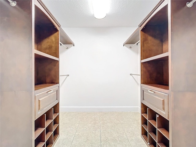 spacious closet featuring light tile patterned floors