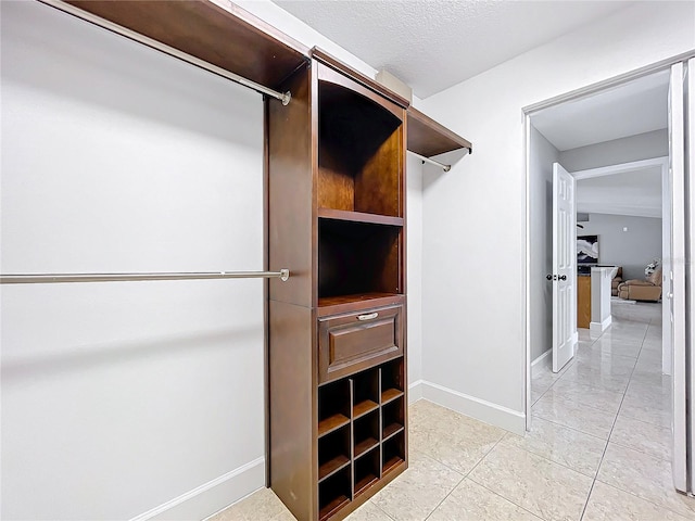 walk in closet featuring light tile patterned floors