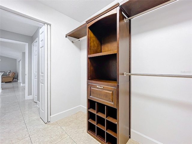 spacious closet featuring light tile patterned floors