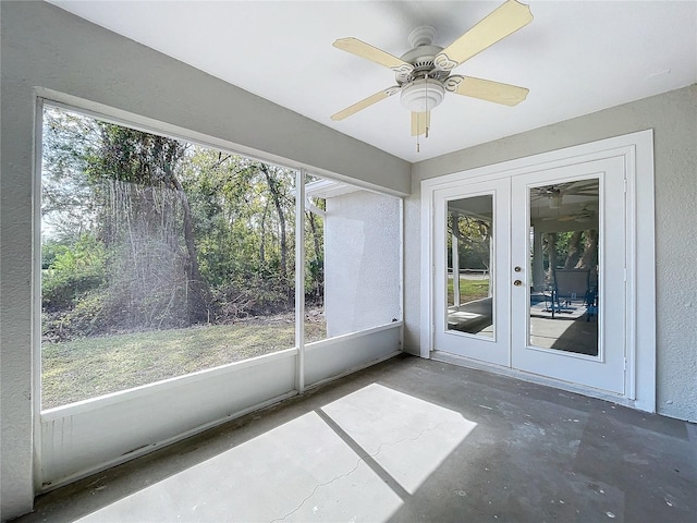 unfurnished sunroom featuring french doors, plenty of natural light, and ceiling fan