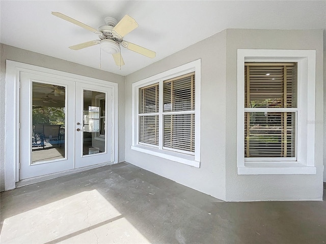 unfurnished sunroom with ceiling fan and french doors