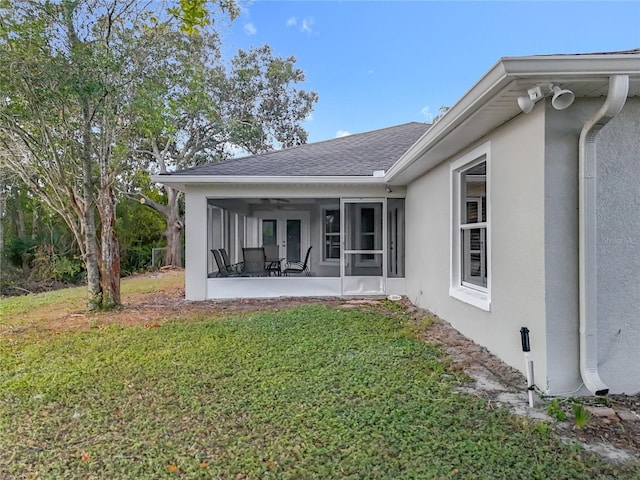 790 Silhouette Ct, Longwood, FL 32750 - back of house with a sunroom, stucco siding, a lawn, roof with shingles, and french doors