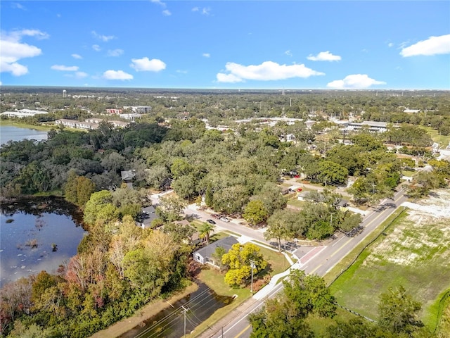 bird's eye view featuring a forest view and a water view