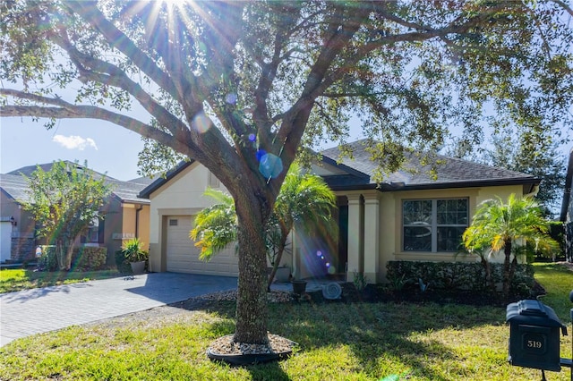 view of front of house featuring a front lawn and a garage