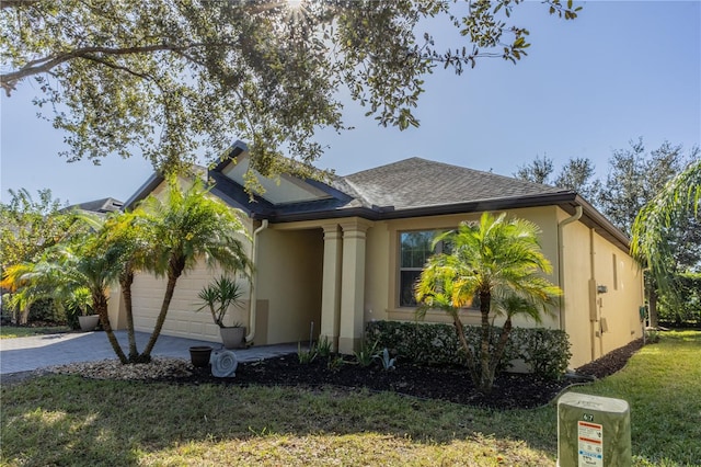 view of front of house featuring a garage and a front lawn