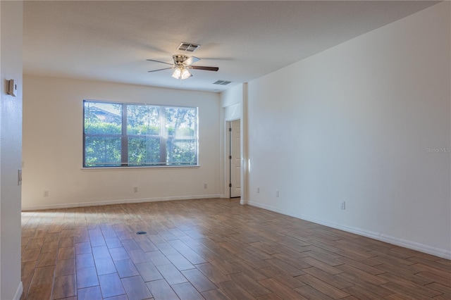 spare room featuring hardwood / wood-style flooring and ceiling fan