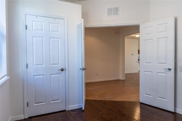 hallway with plenty of natural light and dark hardwood / wood-style flooring