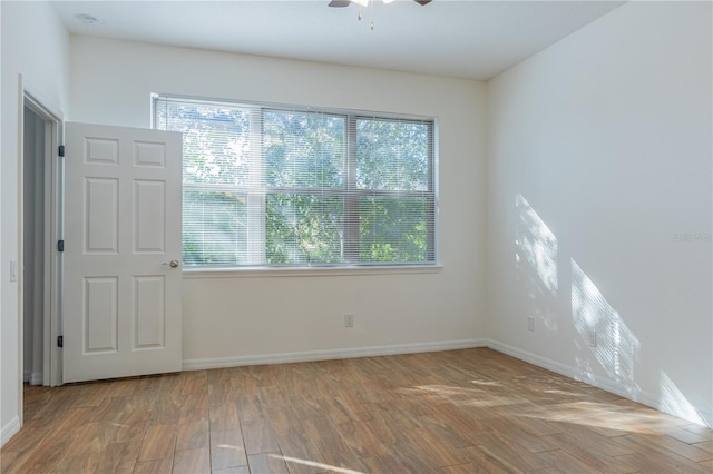 empty room with ceiling fan and wood-type flooring