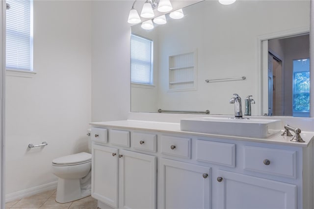 bathroom featuring tile patterned flooring, vanity, and toilet