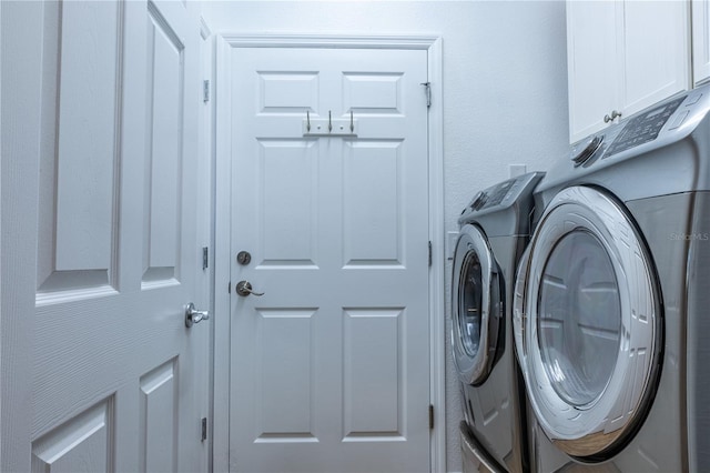 laundry room with cabinets and separate washer and dryer