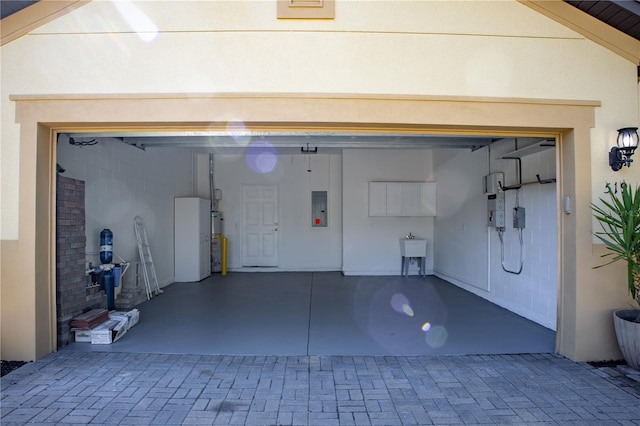 garage featuring sink and electric panel