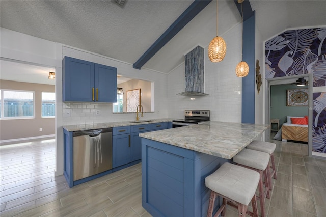 kitchen featuring pendant lighting, sink, a kitchen breakfast bar, stainless steel appliances, and kitchen peninsula