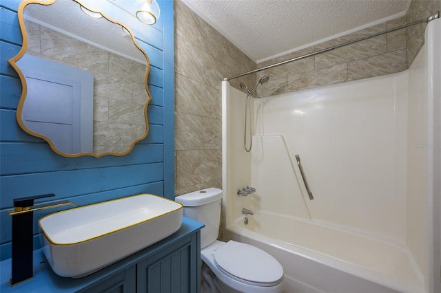 full bathroom featuring vanity, a textured ceiling, bathing tub / shower combination, and toilet