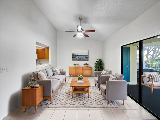 tiled living room featuring vaulted ceiling, a textured ceiling, and ceiling fan