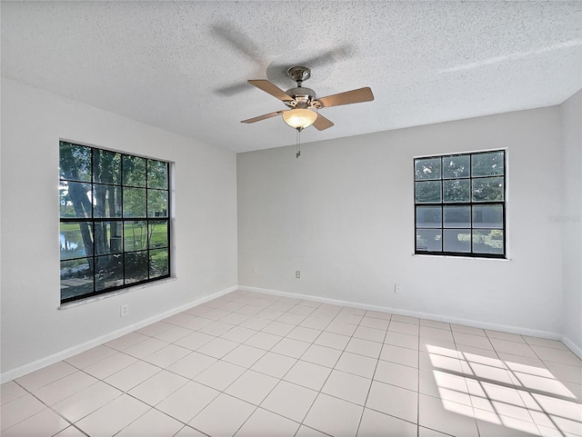 unfurnished room featuring ceiling fan, a textured ceiling, and light tile patterned flooring