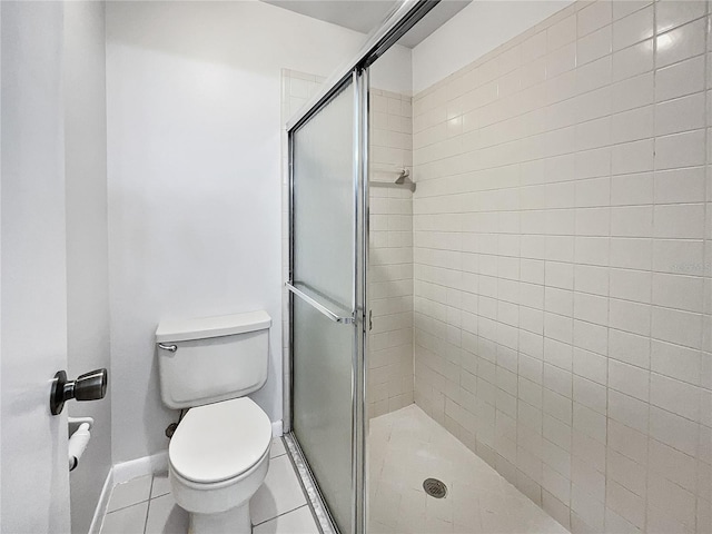 bathroom with toilet, walk in shower, and tile patterned flooring