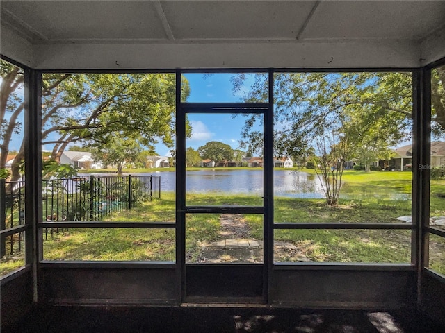 unfurnished sunroom with a water view